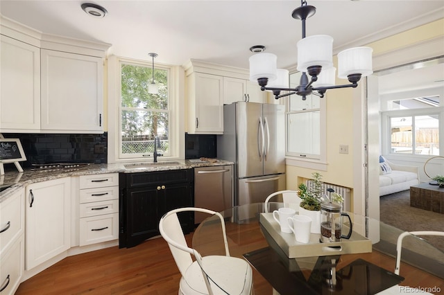 kitchen with backsplash, sink, stainless steel appliances, and a healthy amount of sunlight