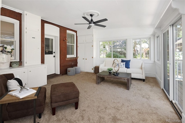 sunroom / solarium featuring ceiling fan