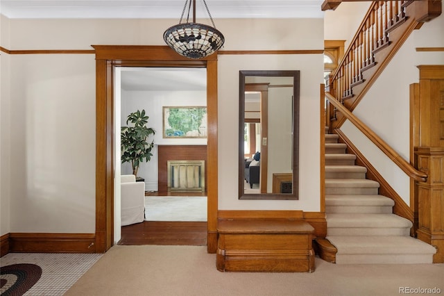 staircase featuring hardwood / wood-style floors and ornamental molding