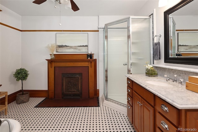 bathroom with ceiling fan, an enclosed shower, tile patterned floors, and vanity