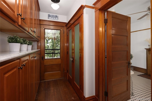 doorway to outside with ceiling fan and dark hardwood / wood-style flooring