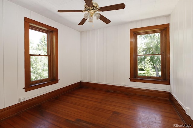 unfurnished room with hardwood / wood-style flooring, ceiling fan, and a wealth of natural light