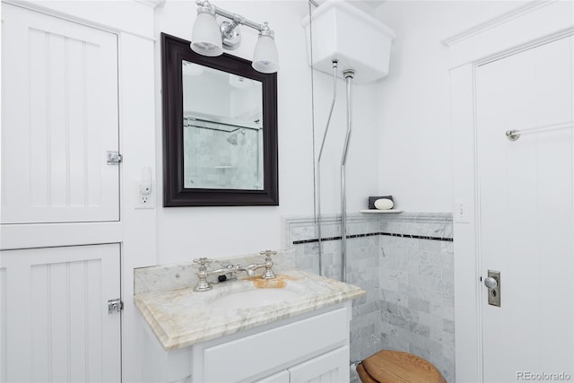 bathroom featuring a shower and vanity