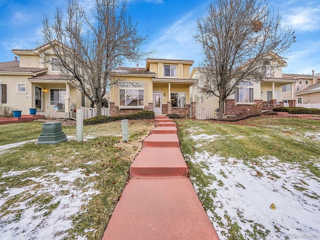 view of front of house with a lawn and a porch