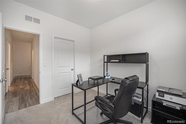 office space featuring baseboards, carpet, and visible vents