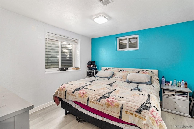 bedroom with light hardwood / wood-style flooring