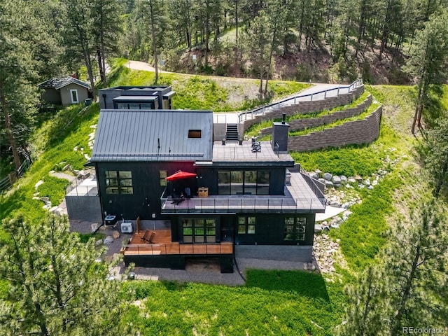 365 Bow Mountain Rd, Boulder, CO 80302 - back of property with a deck, a chimney, a patio area, a wooded view, and stairs