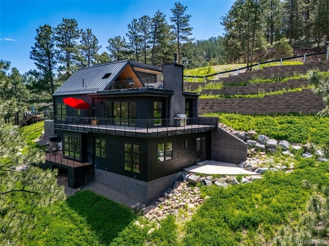 365 Bow Mountain Rd, Boulder, CO 80302 - back of house with a standing seam roof, a metal roof, and a deck