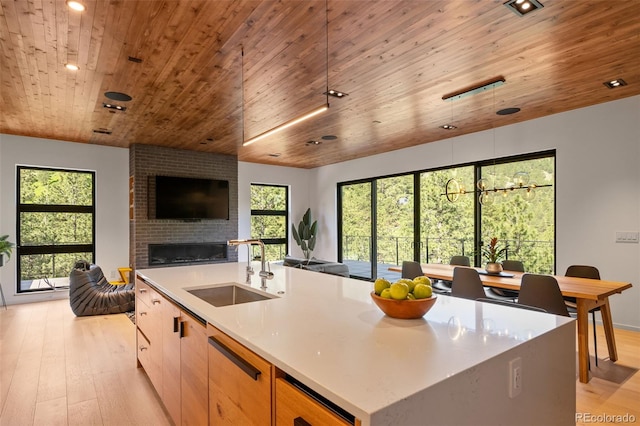365 Bow Mountain Rd, Boulder, CO 80302 - kitchen featuring wood ceiling, open floor plan, light wood finished floors, a brick fireplace, and light countertops