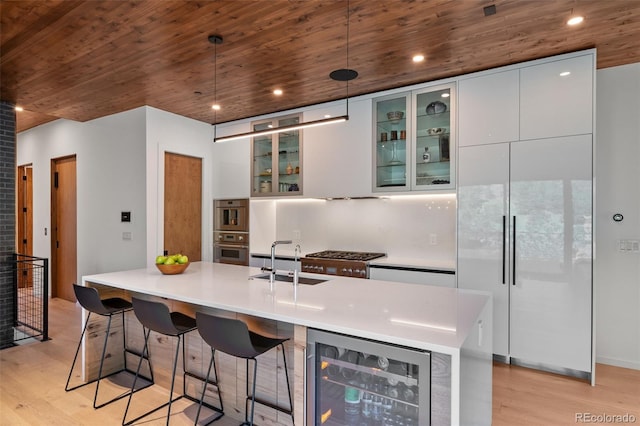 365 Bow Mountain Rd, Boulder, CO 80302 - kitchen featuring wine cooler, light wood-style floors, white cabinetry, wooden ceiling, and decorative light fixtures