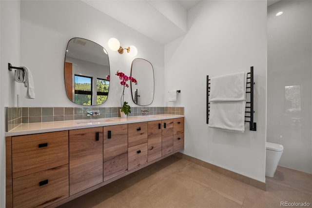 365 Bow Mountain Rd, Boulder, CO 80302 - bathroom featuring a towel warmer, decorative backsplash, and double vanity