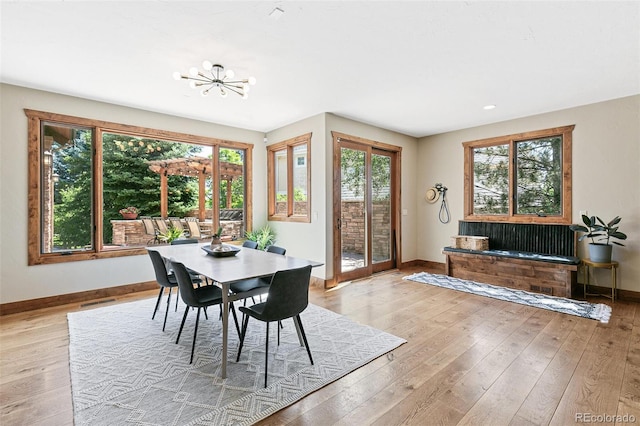 dining area with a healthy amount of sunlight, baseboards, and light wood-style floors