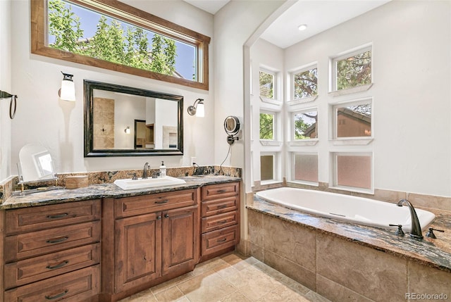 full bathroom featuring vanity and a garden tub