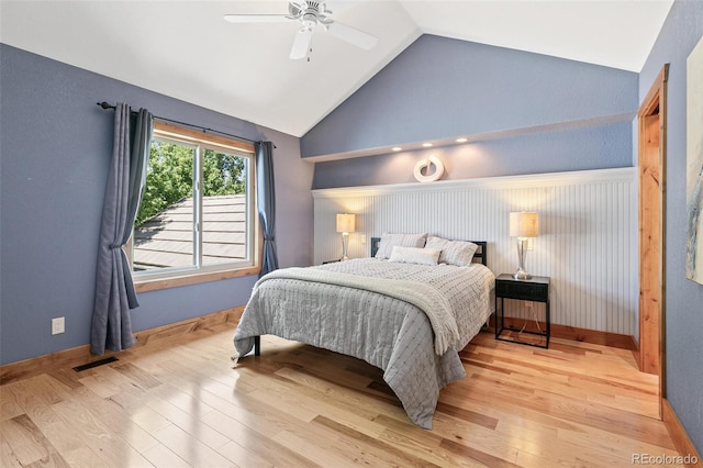 bedroom featuring baseboards, visible vents, high vaulted ceiling, light wood-style flooring, and ceiling fan