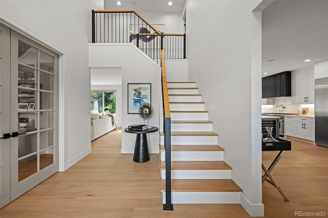 5698 Green Oaks Dr, Greenwood Village, CO 80121 - stairs featuring wood finished floors, recessed lighting, and baseboards