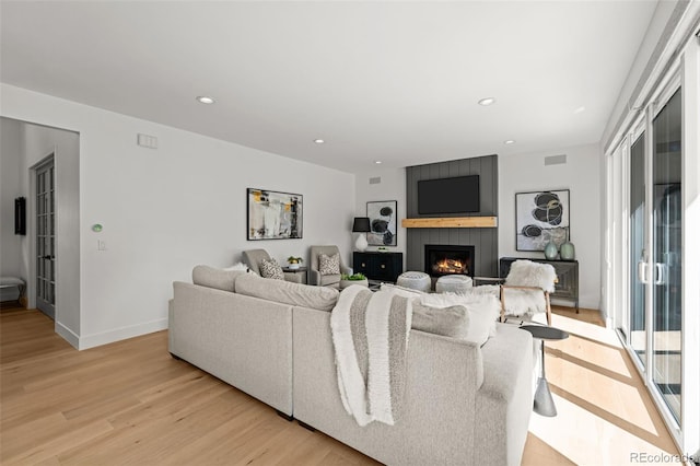 5698 Green Oaks Dr, Greenwood Village, CO 80121 - living area featuring light wood-type flooring, a fireplace, recessed lighting, and baseboards