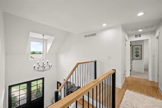 5698 Green Oaks Dr, Greenwood Village, CO 80121 - hall featuring a chandelier, light wood finished floors, french doors, an upstairs landing, and baseboards