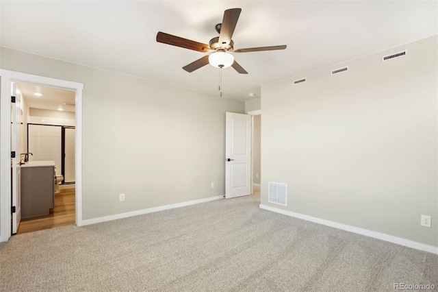 unfurnished bedroom featuring light carpet, baseboards, and visible vents