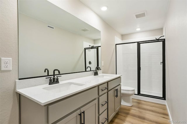 bathroom with visible vents, wood finished floors, and a sink