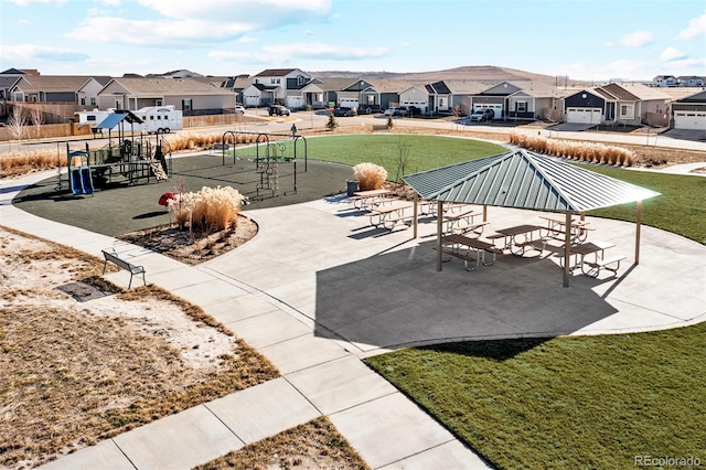 view of patio / terrace featuring a residential view, playground community, and fence