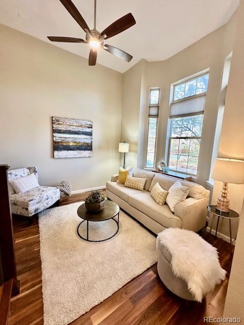 living area featuring a ceiling fan and wood finished floors