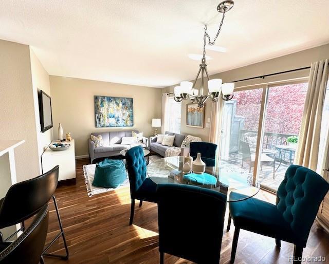 dining room featuring a chandelier, wood finished floors, and a wealth of natural light