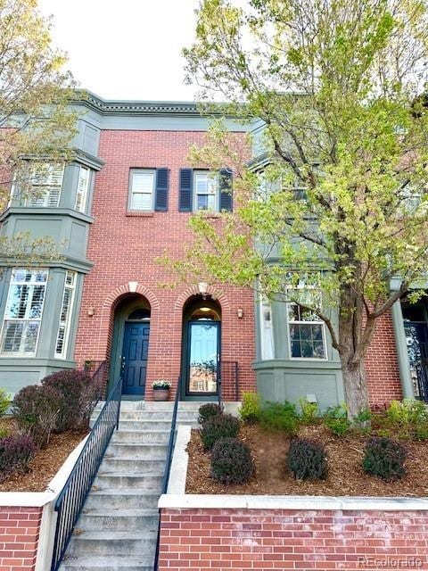 view of property featuring brick siding