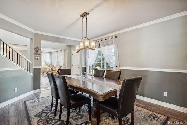 dining area featuring ornamental molding and hardwood / wood-style floors