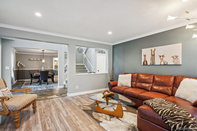 living room with crown molding and hardwood / wood-style floors