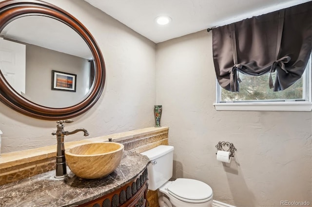 bathroom with toilet and vanity