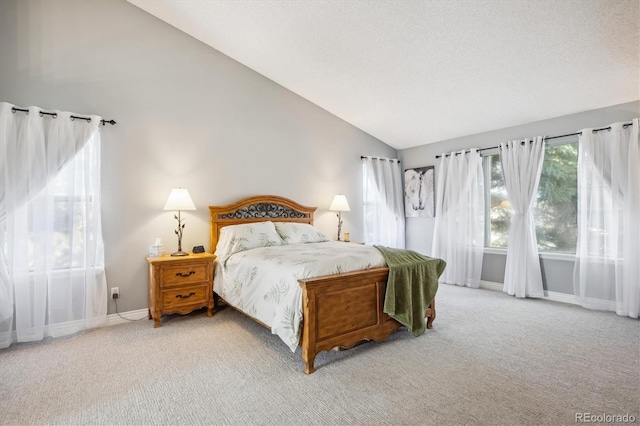 carpeted bedroom featuring lofted ceiling and a textured ceiling