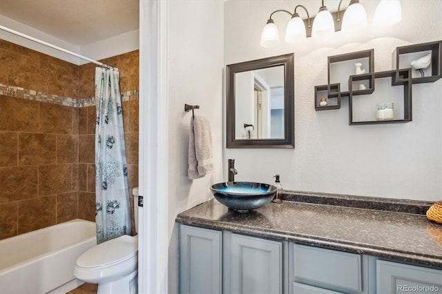 full bathroom featuring vanity, toilet, a textured ceiling, and shower / tub combo with curtain