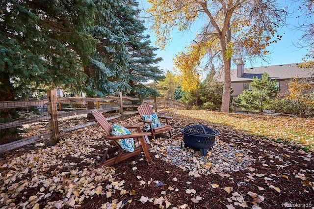 view of yard with an outdoor fire pit