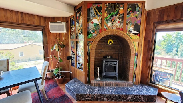 interior space with a wood stove and wood walls