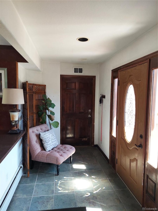 foyer entrance with baseboard heating