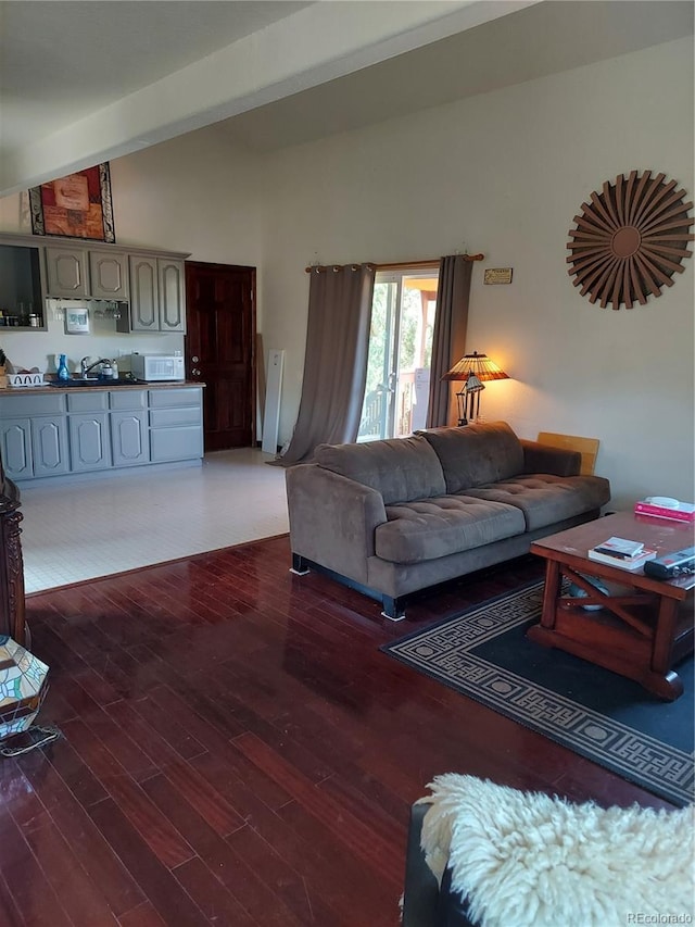 living room with lofted ceiling and dark wood-type flooring