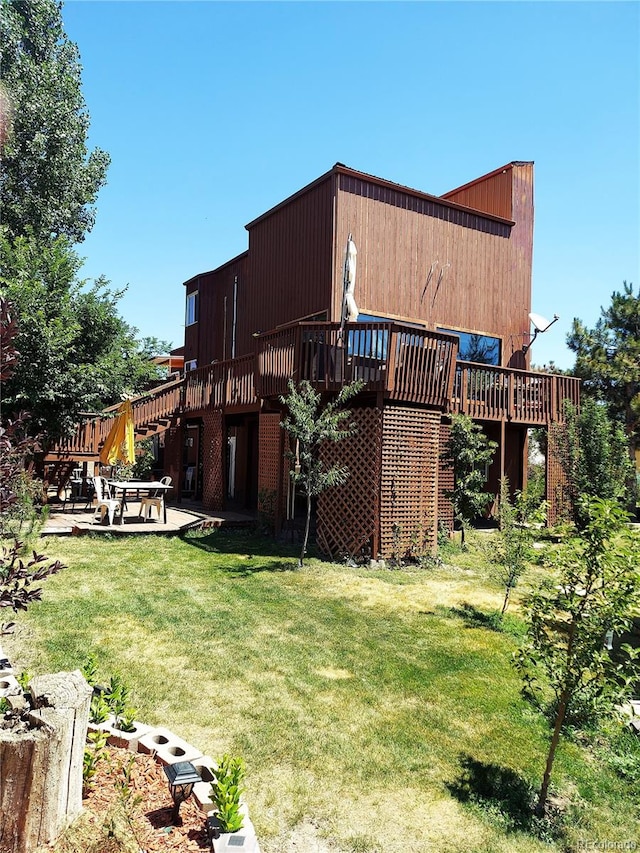 back of property featuring a yard, a patio, and a deck