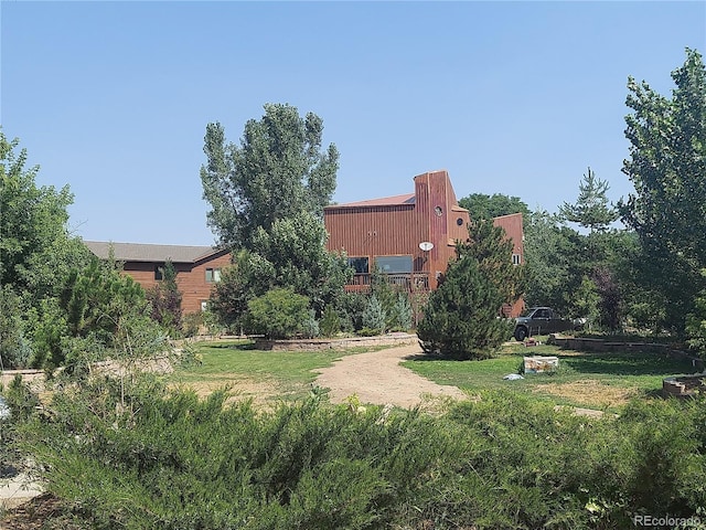 view of home's community with a yard