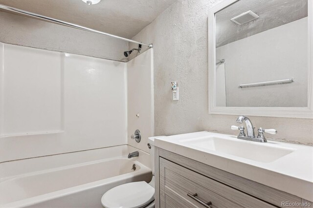 full bathroom featuring vanity,  shower combination, and toilet