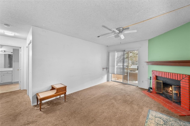 interior space featuring a ceiling fan, carpet floors, a textured ceiling, and a fireplace