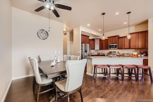 dining room featuring dark hardwood / wood-style floors and ceiling fan