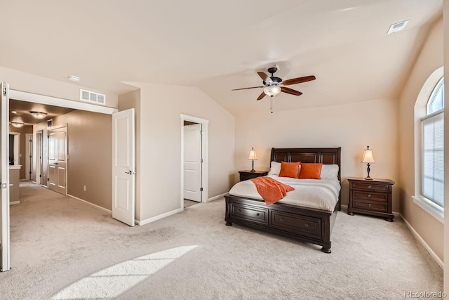 carpeted bedroom with ceiling fan and vaulted ceiling