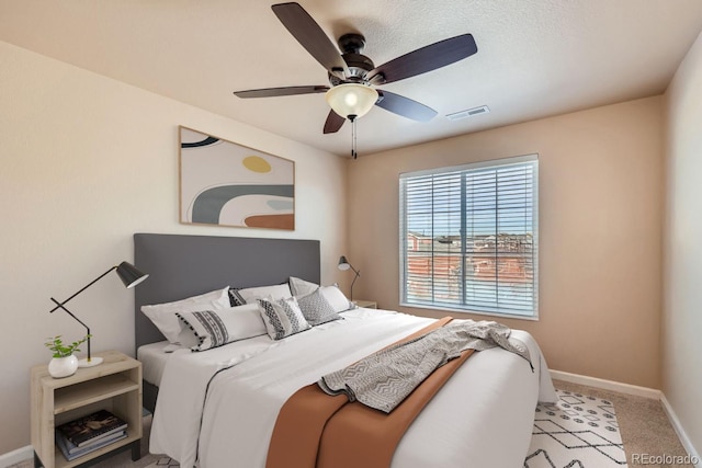 bedroom featuring light carpet and ceiling fan