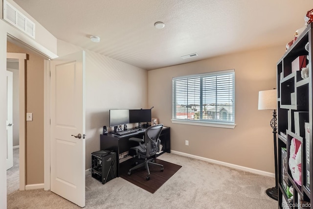 office featuring carpet, visible vents, and baseboards