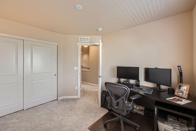 carpeted home office with visible vents and baseboards