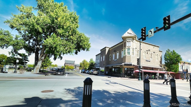 view of street featuring sidewalks, curbs, and traffic lights