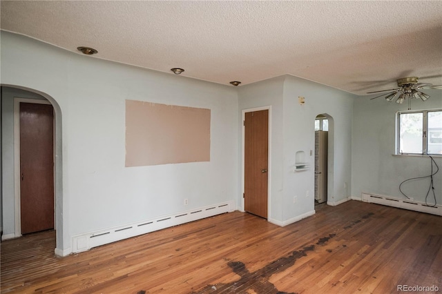 1195 Boston St, Aurora, CO 80010 - spare room with baseboard heating, arched walkways, a ceiling fan, and a textured ceiling