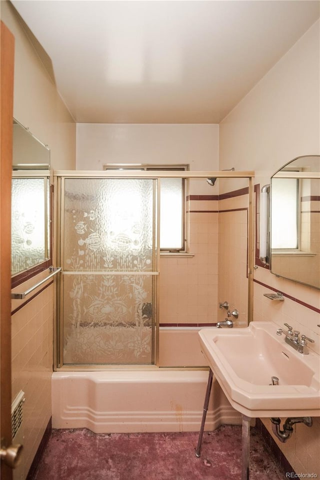 1195 Boston St, Aurora, CO 80010 - bathroom with enclosed tub / shower combo, tile walls, and a sink