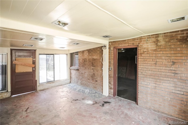 1195 Boston St, Aurora, CO 80010 - spare room featuring brick wall