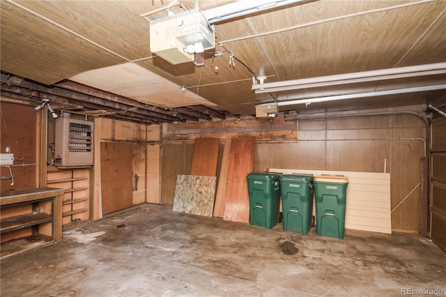 1195 Boston St, Aurora, CO 80010 - garage featuring a garage door opener and wood walls